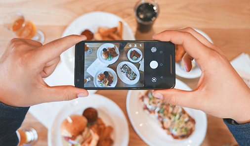 Customer taking image of food for social media.